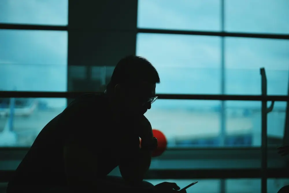 silhouette of man sitting on chair